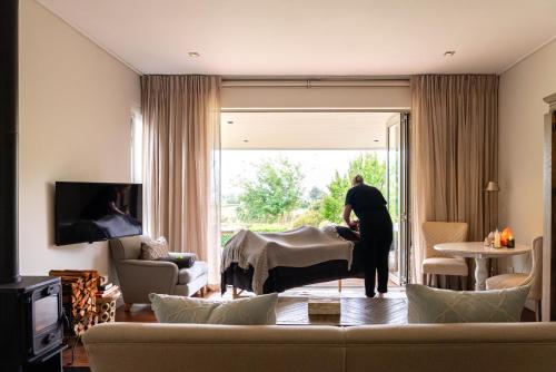 a man standing in a living room with a couch at Angala in Simondium
