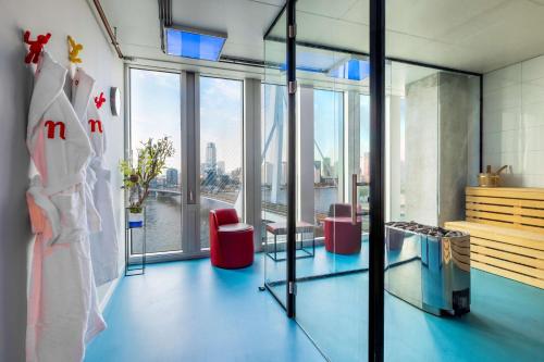 a room with a view of a building with windows at nhow Rotterdam in Rotterdam