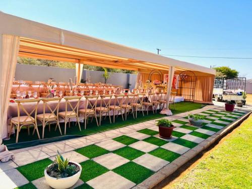 a marquee with tables and chairs on a checkered floor at Minnestay Guest House in Palatswe