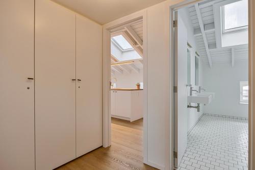a bathroom with white walls and a glass door at Loft City Center - 1 bedroom - parking - by FineNest in Liège