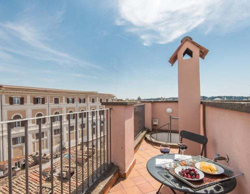 a balcony with a table with food on it at TREVI luxury with terrace in Rome