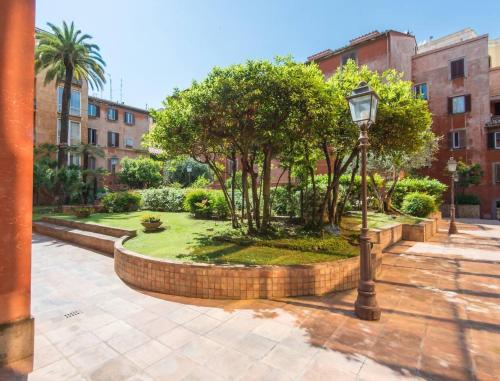 a street light in a courtyard with trees and buildings at TREVI luxury with terrace in Rome
