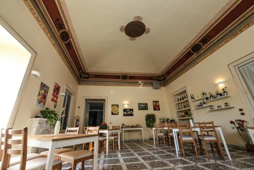 a dining room with a table and chairs at Antica Dimora in Palermo