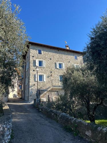 a large stone building with a gate in front of it at Cozy Sommavilla Residence in Brenzone sul Garda