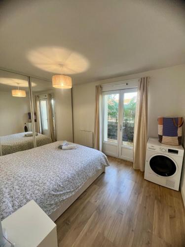 une chambre avec un lit et une grande fenêtre dans l'établissement Magnifique 2P à IGNY proche Saclay, Massy, Versailles, Paris, à Igny