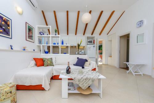 a living room with a bed and a table at Apartment Island Oasis in Koločep