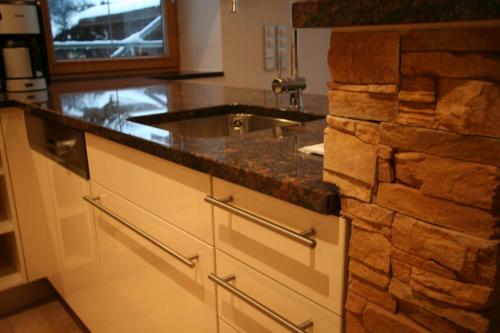a kitchen with a sink and a counter at Landhaus Alpenflair Whg 403 in Oberstdorf