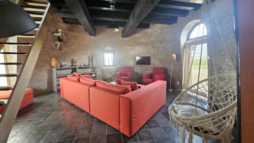 a living room with a red couch and chairs at De goede verwachting in Kamperland