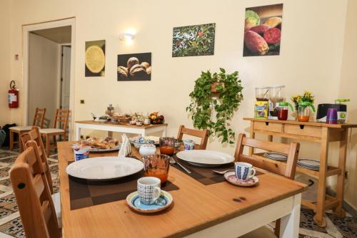 a dining room with a wooden table and chairs at Antica Dimora in Palermo