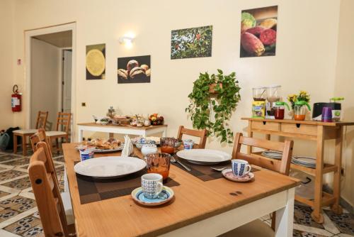 a dining room with a wooden table and chairs at Antica Dimora in Palermo