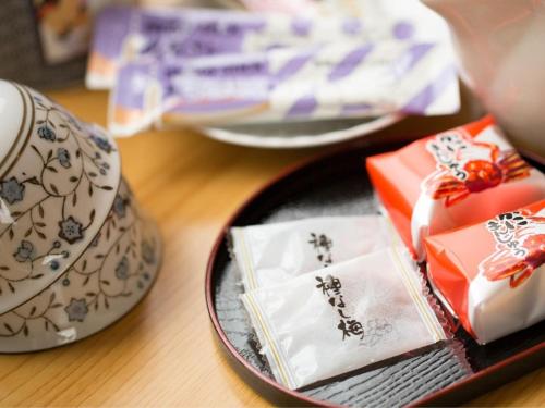 a table topped with three plates of food on a table at 癒しの宿 こえもん in Kami