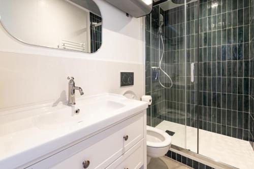 une salle de bain avec un lavabo, une douche et des toilettes dans l'établissement Sept îles - studio - centre-ville - TV, à Vannes
