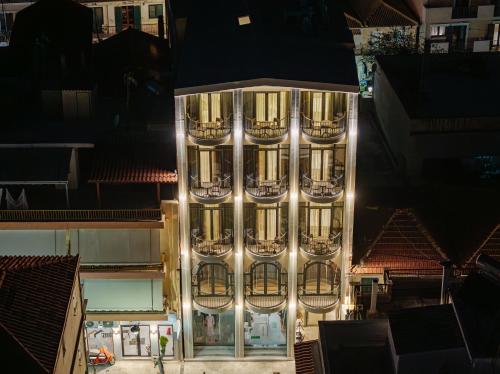 a tall building with lights on it at night at 1864 Apartments in Zakynthos