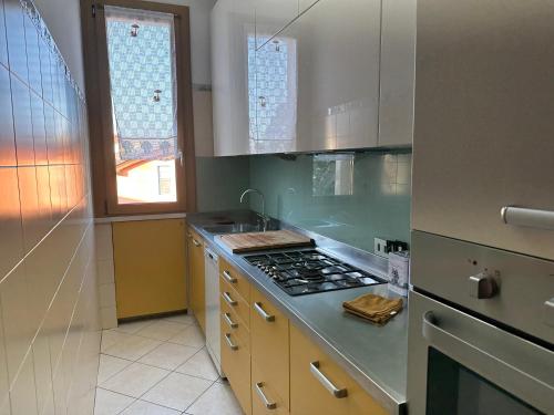 a kitchen with a stove top oven next to a window at Residenza d'autore a Reggio Emilia in Reggio Emilia
