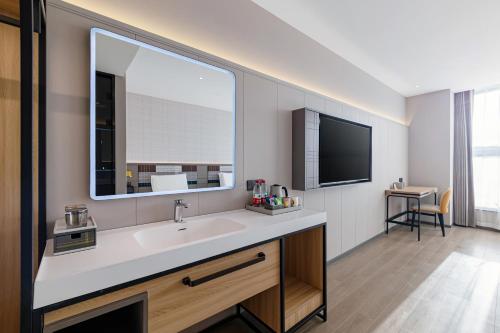 a bathroom with a sink and a large window at HomeInn Plus at China Intl Exhibition Center and Liufang Subway Stn in Beijing