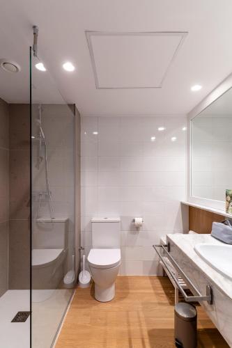 a bathroom with a toilet and a shower and a sink at Prestige Goya Park in Roses