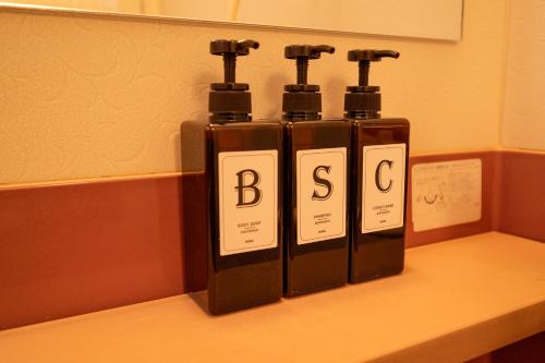 three bottles of wine sitting on top of a counter at 中町ハウス in Biei