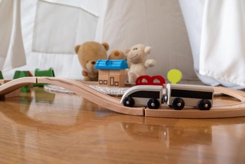 a toy train on a wooden bridge with teddy bears at 中町ハウス in Biei