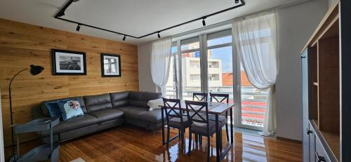 a living room with a couch and a table at Apartment Blue Green Virovitica in Virovitica