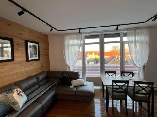 a living room with a couch and a table at Apartment Blue Green Virovitica in Virovitica