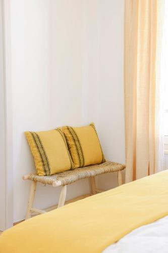 a chair with a pillow on it next to a bed at Bed & Breakfast alle Cantine in Salorino