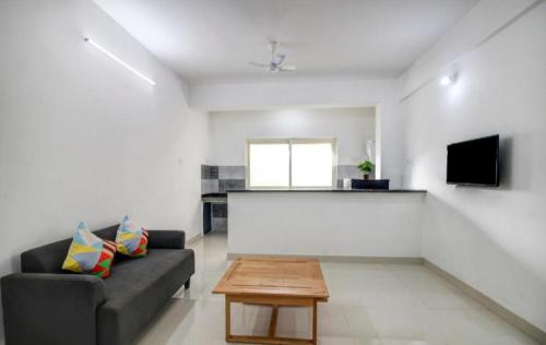 a living room with a couch and a table at Exotic star 1 BHK 2BHK Apartment in Socorro