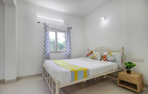 a bedroom with a bed and a window at Exotic star 1 BHK 2BHK Apartment in Socorro