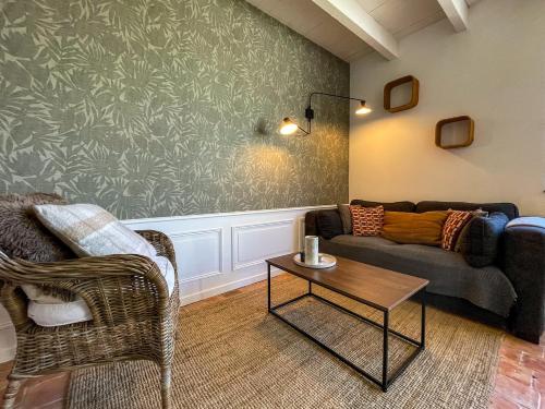 a living room with a couch and a table at Ty Cosy-Charme et Confort au Coeur de la Bretagne in Plouézec