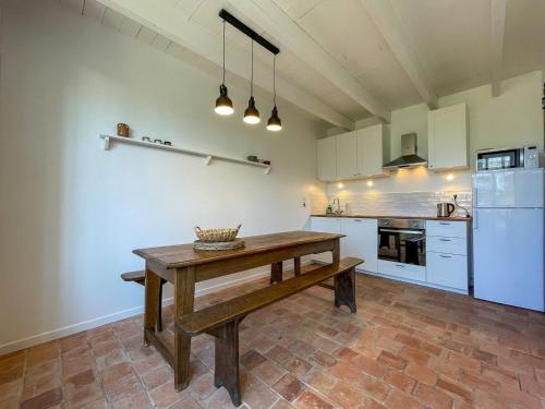 a kitchen with a wooden table in the middle at Ty Cosy-Charme et Confort au Coeur de la Bretagne in Plouézec