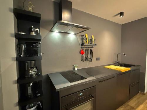 a kitchen with a sink and a stove top oven at Casbah, suites nel cuore di Menaggio in Menaggio