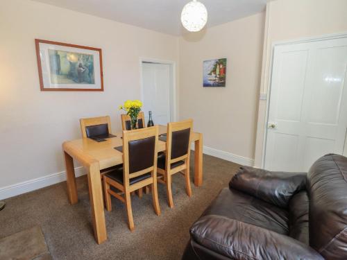 a living room with a table and a couch at South View in Leyburn