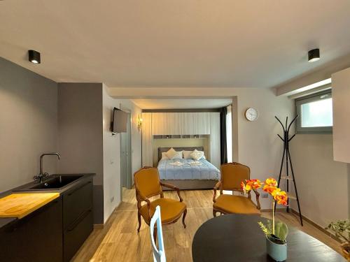 a bedroom with a bed and a table and chairs at Casbah, suites nel cuore di Menaggio in Menaggio