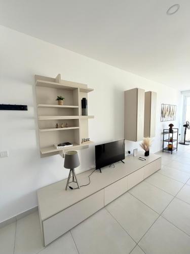 a living room with a tv on a white wall at Duplex Penthouse in Sliema in Sliema