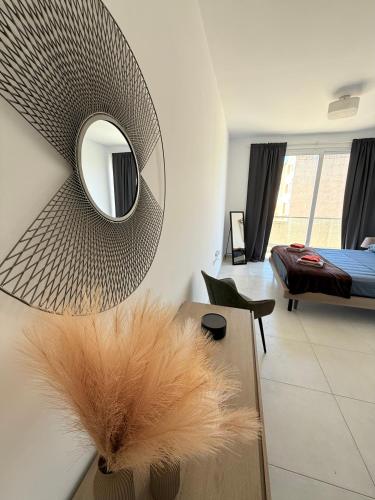 a living room with a mirror and a vase with feathers at Duplex Penthouse in Sliema in Sliema