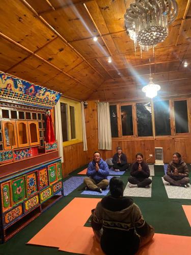 a group of people sitting on the floor in a room at Sherpa Panorama Hotels in Khumjung