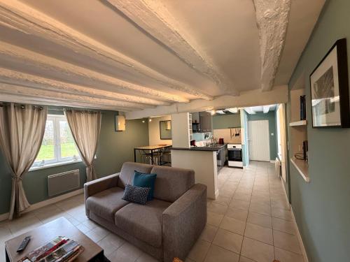 un salon avec un canapé et une cuisine dans l'établissement Clos des Huards au milieu de la loire à vélo, à Cour-Cheverny