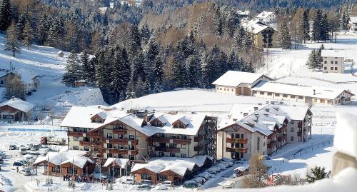 an aerial view of a resort with snow covered buildings at Golf Hotel in Folgaria