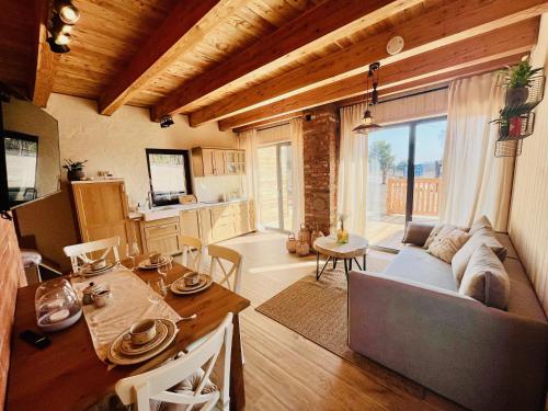 a living room with a couch and a table at Cztery Pory Roku Swornegacie in Swornegacie 