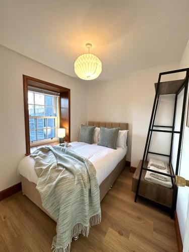 a bedroom with a bed with a ladder and a window at Barossa Nook, 2 Bedroom House in Perth