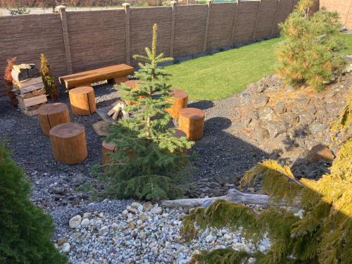 a garden with a bench and trees and rocks at Amia Chalet in Veľká Lomnica