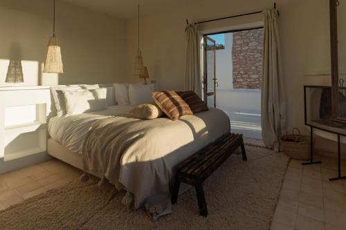 a bedroom with a large bed and a window at La Mouette et les Dromadaires in Essaouira