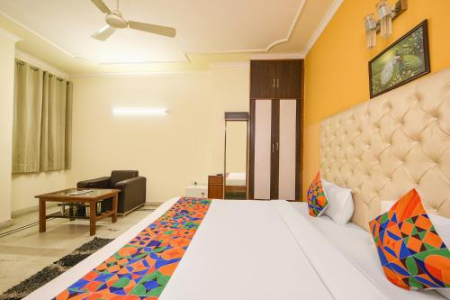 a hotel room with a bed and a desk at Hotel Gracious - Civil Line in Gurgaon