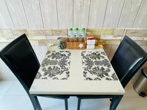 a table with two chairs and a table with drinks on it at The base Condo luxury room by Numam in Pattaya Central