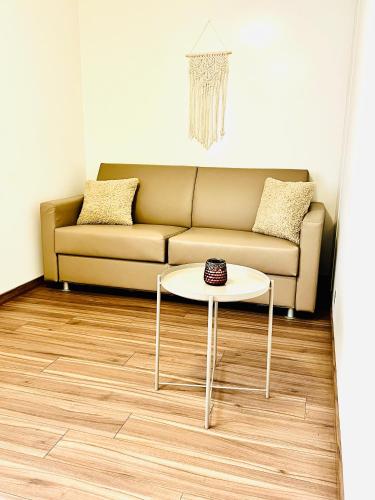 a living room with a couch and a table at Hôtel Domaine de la Sauge in Cudrefin