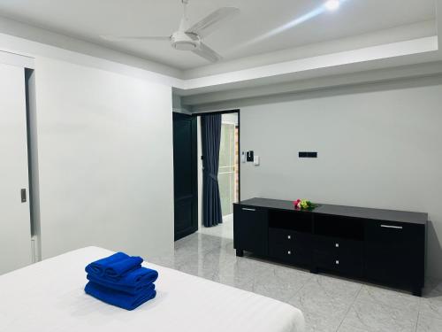 a bedroom with a bed and a black dresser at Patong best location Apartments, 2 bedrooms in Patong Beach