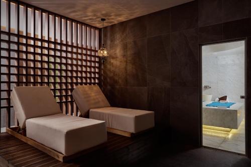 a living room with a chair and a tub at Gennadi Grand Resort in Gennadi