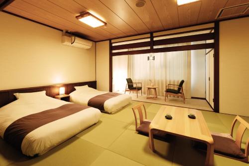 Ένα ή περισσότερα κρεβάτια σε δωμάτιο στο Hotel Yutoria Fujisato