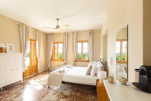 a bedroom with a bed and a large mirror at Villa Plaka 16 "The Bordeaux"-Drepano Nafplio in Drepana