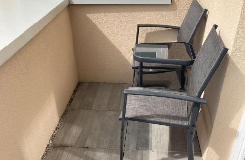 a chair sitting in the corner of a room at RIOs Apartments in Scharnitz