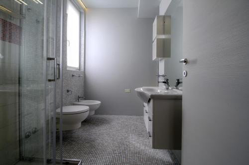 a bathroom with a toilet and a sink and a shower at La Cordata Accommodation - Martinelli 55 - Mono 7 in Rho